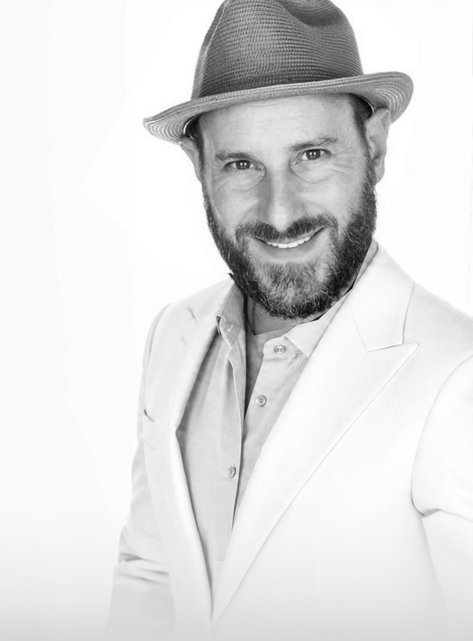 Jeffrey Stein, founder of Burnwater Ventures, in a white suit and hat